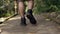 an Asian man is walking on a path in a forest