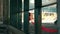 an Asian man walks in an abandoned building with a red cloth hanging down