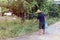 Asian man watering his garden.