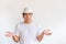 Asian man wear white hat raise hand up with boring expression em