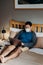 Asian man weared medical mask. Sitting and using laptop in bedroom