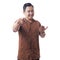 Asian Man Wearing Batik Shirt Smiling and Pointing Forward