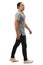 Asian man wearing grey shirt black denim and white shoes, walking forward, side view, happy confidence expression. Full body