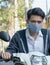 Asian man wearing a mask to lessen traffic pollution