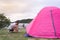 An Asian man in white t shirt setting pink tent