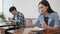 Asian man and woman having lunch meal in local restaurant, sit in social distance. Business reopening, social distancing culture