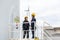 Asian man and woman Inspection engineers preparing and progress check of a wind turbine with safety in wind farm in Thailand