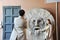 Asian man and woman photograph each other in front of the mouth of truth Bocca della VeritÃ .