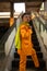 an Asian man in a yellow suit is standing on a broken elevator