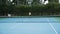 Asian mans dressed in tennis blue suits spending time on court,playing tennis on sunny day,holding a tennis racket