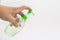 Asian mans hand holds a gel alcohol pump bottle and ready to pushes on it. It`s an isolated object on the white clear screen in