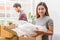 Asian married couple start new family life concept. Woman and man unpacking messy boxes after moving in new house together