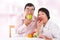 Asian mature couple eating apple