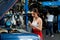 Asian mechanic woman take care engine of car by filling some chemical in the front of car and work in garage workplace