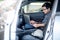 Asian mechanical engineer using laptop in the car