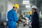 Asian mechanical worker male working on milling machine in factory. Technicians wear protective glasses and helmet when operating