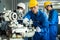 Asian mechanical workers working on milling machine. The technicians wearing protective glasses and helmet when operating the mach