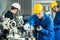 Asian mechanical workers working on milling machine. The technicians wearing protective glasses and helmet when operating the mach