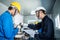 Asian mechanical workers working on milling machine. The technicians wearing protective glasses and helmet when operating the mach