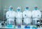 Asian medical scientists wearing protective suit and face mask  diagnosis vaccine virus in science clinical