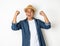 Asian men aged around 30 wearing hats and jeans feeling happy celebrate with two hand stretch on white background