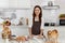 Asian middle-aged woman kneading dough for baking happy and smile in the home kitchen. concept dessert love and bond