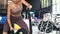 Asian mixed female bodybuilder practicing crossfit battle ropes with motion at fitness gym