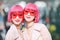 Asian models with pink bob hair wear a pair of semitransparent red glasses during the Armani fashion show at the women`s fashion w