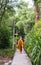 A asian monk walks on the walkway