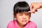 Asian mother cuts her daughter`s hair by herself at home. Mom cuts hair for a cute little girl. Stay home safe from corona virus
