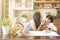 Asian mother and daughter enjoy eating the same bread