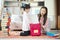 An Asian mother and daughter pack her backpacks to school preparing to go to school