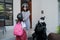asian mother fasten her daughter helmet before going to school