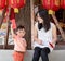 Asian mother give a red envelope or Ang-pow to son