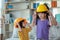 Asian mother helping daughter wearing engineer helmet, education and occupation concept