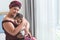 Asian mother holding baby half Nigerian half Thai, is 2-month-old baby newborn son