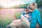 Asian Mother is kissing her child in nature outdoor with face mask took off for family freedom and happiness after pandemic.