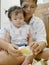 Asian mother`s hands peeling fruit, pomelo, for her daughter