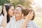 Asian mother and son show love for grandmother by kiss cheeks at the park in the morning. The concept of family lifestyle on the