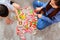 Asian mother work home together with son. Mom and kid play color wooden block. Child creating building toy.