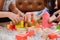 Asian mother work home together with son. Mom and kid play color wooden block. Child creating building toy.