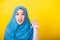 Asian Muslim Arab woman Islam wear hijab smile she positive expression pointing with finger up