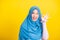 Asian Muslim Arab woman Islam wear hijab smile she showing gesture fingers in okay gesture symbol