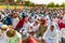 Asian Muslim devotees sitting in a row getting ready for Eid Prayers.