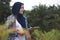 Asian muslim female farmer supervise her ginger plants cultivation. Organic farming