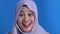 Asian muslim lady shows surprised or shocked expression with open mouth, close up facial expression