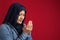 Asian muslim woman prays to God, praying gesture hands raised up, Islam religion spiritual life