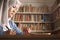 Asian muslim woman studying in library, exam preparation concept. Female college student doing research and making notes in her