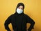 Asian muslim woman wearing hijab and mask during coronavirus covid pandemic new normal, woman wearing face protective mask,