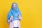 Asian muslim woman wearing hijab and medical mask over isolated background celebrating surprised
